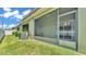 Covered screened-in patio overlooking the yard, with outdoor furniture and access to the garden at 2622 Lantern Hill Ave, Brandon, FL 33511