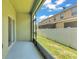 A screened-in patio provides a relaxing view of the green backyard and white vinyl fence at 2622 Lantern Hill Ave, Brandon, FL 33511