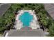 Aerial view of a community pool featuring lounge chairs and lush landscaping at 2622 Lantern Hill Ave, Brandon, FL 33511