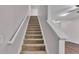 Carpeted staircase with white railing leading to the upper level of the home at 2622 Lantern Hill Ave, Brandon, FL 33511
