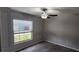 Bedroom showcasing a window with blinds, ceiling fan, and carpeted flooring at 3188 Nubbin Ridge Ln, Zephyrhills, FL 33540