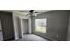 This bedroom has carpeted floors, a ceiling fan, a window with blinds, and a closet at 3188 Nubbin Ridge Ln, Zephyrhills, FL 33540