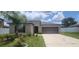 Well-manicured front exterior with lush lawn, mature landscaping and covered front entryway at 3188 Nubbin Ridge Ln, Zephyrhills, FL 33540