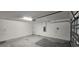 Clean two-car garage featuring bright lighting, automatic door, and ample space at 3188 Nubbin Ridge Ln, Zephyrhills, FL 33540