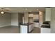 Open concept kitchen with an island, granite countertops, and modern cabinets at 3188 Nubbin Ridge Ln, Zephyrhills, FL 33540