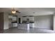Bright and open living room with a ceiling fan, recessed lighting, and an adjacent kitchen at 3188 Nubbin Ridge Ln, Zephyrhills, FL 33540