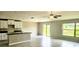 Bright living room featuring tile flooring, a ceiling fan, and sliding glass doors to the backyard at 3188 Nubbin Ridge Ln, Zephyrhills, FL 33540