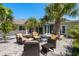 Paver patio with outdoor seating surrounded by palm trees and lush landscaping, perfect for entertaining at 3626 Corsair Ct, New Port Richey, FL 34652