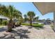 Waterfront patio with brick pavers, palm trees and outdoor furniture offers a relaxing outdoor space at 3626 Corsair Ct, New Port Richey, FL 34652