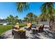 Backyard with a paver patio, comfortable seating, palm trees, and waterfront views at 3626 Corsair Ct, New Port Richey, FL 34652