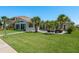 Expansive backyard with patio, lush lawn, and waterfront views, ideal for outdoor living at 3626 Corsair Ct, New Port Richey, FL 34652