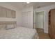 Well-lit bedroom with a closet and adjacent access to another bedroom at 3626 Corsair Ct, New Port Richey, FL 34652