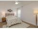 Bright bedroom featuring a decorative headboard, beach-themed decor and a ceiling fan at 3626 Corsair Ct, New Port Richey, FL 34652