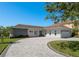 Charming single-story home featuring a brick driveway, attached garage, and manicured landscaping at 3626 Corsair Ct, New Port Richey, FL 34652