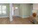 Bright foyer featuring wood floors, a front door with sidelights, and neutral walls at 3626 Corsair Ct, New Port Richey, FL 34652