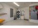 Well-organized garage featuring epoxy floors, utility sink, and stackable washer dryer at 3626 Corsair Ct, New Port Richey, FL 34652