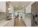 Clean kitchen featuring white cabinets, stainless appliances, and wood look floors at 3626 Corsair Ct, New Port Richey, FL 34652