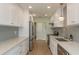 Clean kitchen featuring white cabinets, stainless appliances, and wood look floors at 3626 Corsair Ct, New Port Richey, FL 34652