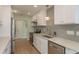 Bright kitchen featuring white cabinets, stainless appliances, and wood look floors at 3626 Corsair Ct, New Port Richey, FL 34652