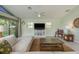 Comfortable living room with a modern ceiling fan, neutral walls, and large windows at 3626 Corsair Ct, New Port Richey, FL 34652