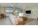 Spacious living room with high ceilings, a large sectional, and beautiful waterfront views at 3626 Corsair Ct, New Port Richey, FL 34652