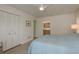 Bright main bedroom featuring neutral decor, closet, and access to a bathroom at 3626 Corsair Ct, New Port Richey, FL 34652