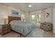 Bright main bedroom featuring neutral decor, ceiling fan, and an exterior door at 3626 Corsair Ct, New Port Richey, FL 34652