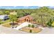 Aerial shot of home with lush trees, manicured lawn and charming neutral stucco exterior at 5370 Boxtree Ct, Dade City, FL 33523