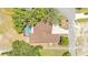 Aerial view of the property, featuring a pool, mature trees, and serene backyard space at 5370 Boxtree Ct, Dade City, FL 33523