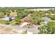 Aerial view of home showcasing mature landscaping, neutral stucco exterior and peaceful surroundings at 5370 Boxtree Ct, Dade City, FL 33523