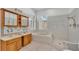Bathroom featuring tile floors, soaking tub, vanities, and a separate walk-in shower at 5370 Boxtree Ct, Dade City, FL 33523