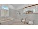 Bathroom featuring tile floors, soaking tub, and a separate walk-in shower at 5370 Boxtree Ct, Dade City, FL 33523