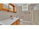 Cozy bathroom with traditional wallpaper, vanity sink, and shower tub combo at 5370 Boxtree Ct, Dade City, FL 33523