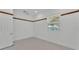 Bright bedroom with a window allowing for natural light and white walls and decorative wood trim at 5370 Boxtree Ct, Dade City, FL 33523