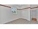 Bedroom featuring a closet, bright window, and white walls and light tile flooring at 5370 Boxtree Ct, Dade City, FL 33523