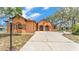 Stunning exterior elevation featuring stucco finish, stone accents, and a spacious concrete driveway with ample parking at 5370 Boxtree Ct, Dade City, FL 33523