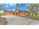 Beautiful exterior elevation featuring an attached garage, ample parking and a view of the well manicured lawn at 5370 Boxtree Ct, Dade City, FL 33523