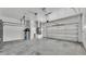 Spacious garage interior with white walls, concrete floors, and ample space for parking and storage at 5370 Boxtree Ct, Dade City, FL 33523