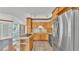 Open kitchen with stainless appliances, wooden cabinets and cooktop island overlooking pool at 5370 Boxtree Ct, Dade City, FL 33523