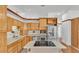 Bright kitchen featuring stainless steel appliances, wooden cabinets and cooktop island at 5370 Boxtree Ct, Dade City, FL 33523