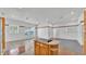 Open floor plan with kitchen featuring cooktop island, views into dining area at 5370 Boxtree Ct, Dade City, FL 33523