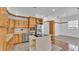 Spacious kitchen with stainless steel appliances, island cooktop and wooden cabinets at 5370 Boxtree Ct, Dade City, FL 33523