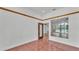 View of living room with tile floor, doorway and a large window with a backyard view at 5370 Boxtree Ct, Dade City, FL 33523