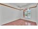 Bright living room featuring a large arched window and unique tile flooring at 5370 Boxtree Ct, Dade City, FL 33523
