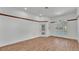 Bright living room features wood flooring, an exit to pool area, and an arched window at 5370 Boxtree Ct, Dade City, FL 33523