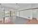 A spacious living room with tile flooring and glass sliding doors, providing access to outdoor amenities at 5370 Boxtree Ct, Dade City, FL 33523