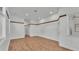 Open floor plan showing living room featuring wood floors, white walls, and access to other rooms at 5370 Boxtree Ct, Dade City, FL 33523