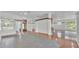 Open-concept living space features tile floors, and multiple windows creating a bright and airy atmosphere at 5370 Boxtree Ct, Dade City, FL 33523