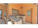 Outdoor kitchen with granite countertops, sink, bar seating, and convenient access to the pool area at 5370 Boxtree Ct, Dade City, FL 33523