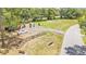 An aerial view of a well-maintained park complete with benches and flagpoles adds charm to the community at 5370 Boxtree Ct, Dade City, FL 33523